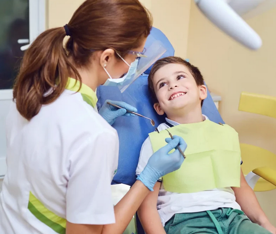 A friendly dentist interacting with a happy child during a routine check-up at the best dentist in Penrith