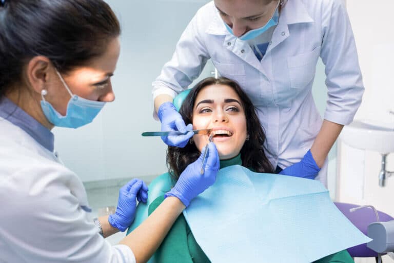 Are Dentists Doctors? Dental Titles and Training in Australia 1 Dental team examining a patient in the dental chair