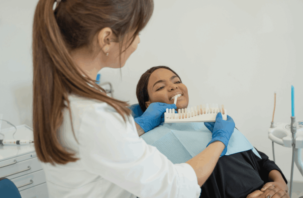Oil Pulling and Teeth: Does It Work? 1 Dental practitioner showing a tooth shade guide to a patient