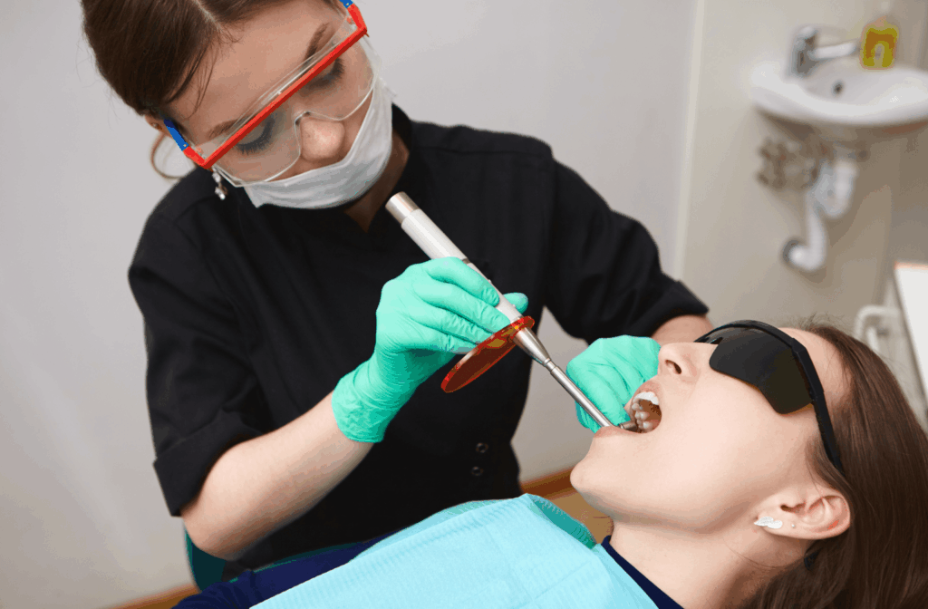 How Long After a Teeth Cleaning Can I Eat? 1 Dental practitioner cleaning a patient's teeth