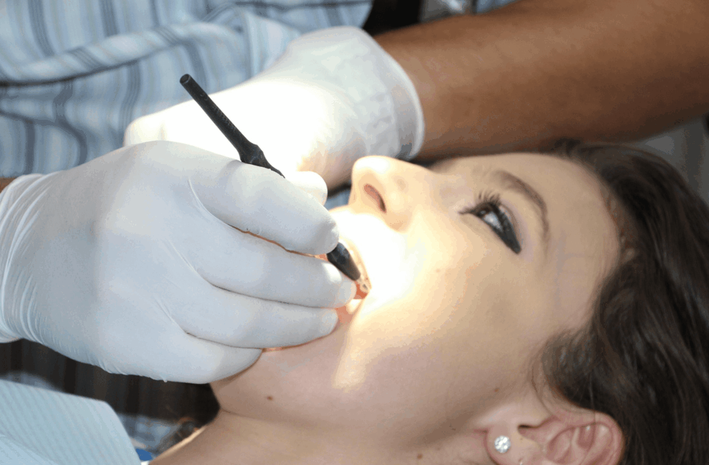 Can Dentists Prescribe Antibiotics and Pain Medication? 1 Dentist treating a patient in the dental chair